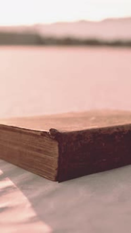 Old Book on the Sand Beach