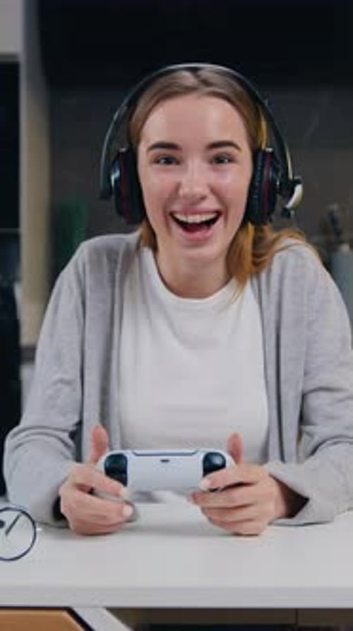 Excited Woman Gaming with Controller and Headset