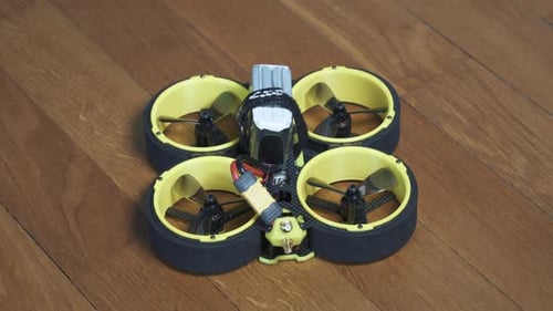 Close up shot of FPV drone BumbleBee CineWhoop with LiPo battery plugged in