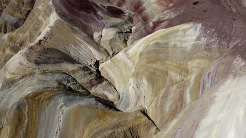 Steep colourful smooth eroded mountain slope, aerial flyover in ARG