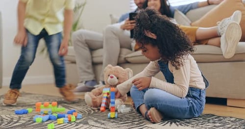 Family Relaxing at Home While Children Play
