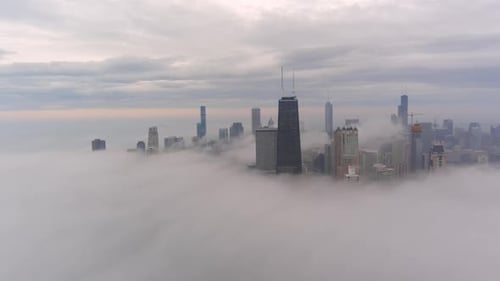 A chicago skyline consist of misty clouds. Foggy, white, beautiful, view of John Hancock tower and t