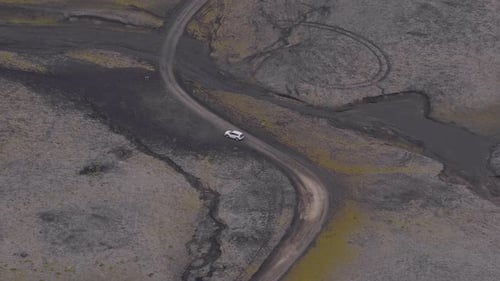 Aerial View of Vehicle on Winding Dirt Road in Volcanic Iceland