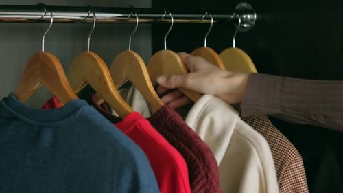 Hand Selects Cream Colored Sweater from Wardrobe