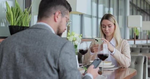 Young Couple Ordering Food Online at Restaurant Table Looking Online Cafe Menu Together Technology