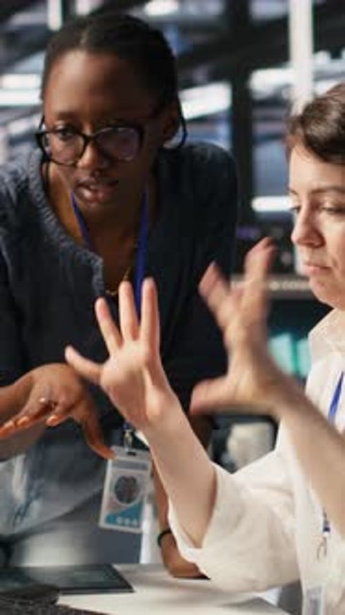 Vertical Video Data Center Technicians Adjusting Blade Server Hardware Powering AI