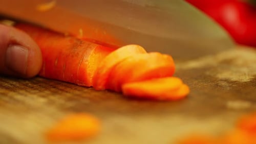 Bright Carrot Sliced on Wooden Cutting Board