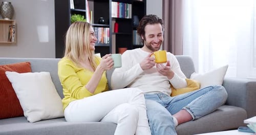 Couple Relaxing and Chatting at Home with Coffee