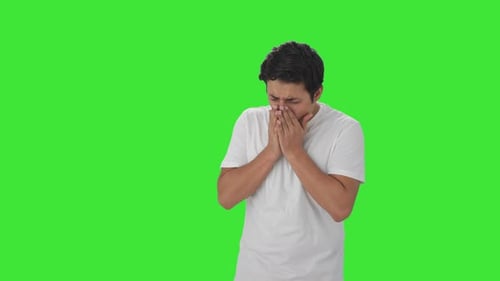 Sick Indian man having cold and cough Green screen