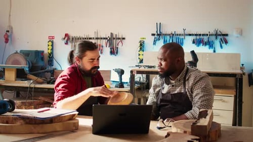 Team of Manufacturers Discussing Furniture Assembly Schematics