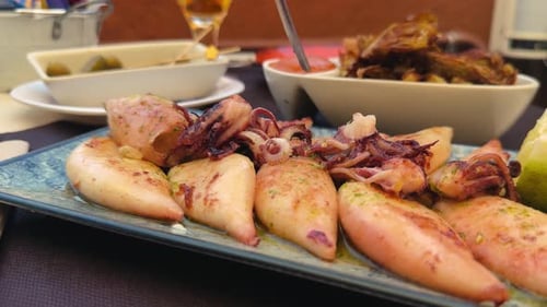 Baby squid in basil-lemon sauce, fried artichoke and juicy green olives with a cold fresh beer.