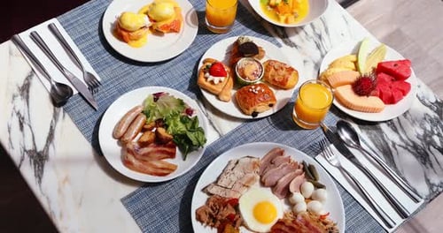 Breakfast buffet overhead shot with fruit, pastries, eggs