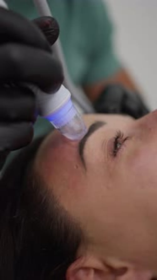 Cosmetic Procedure on Woman's Face in Clinic