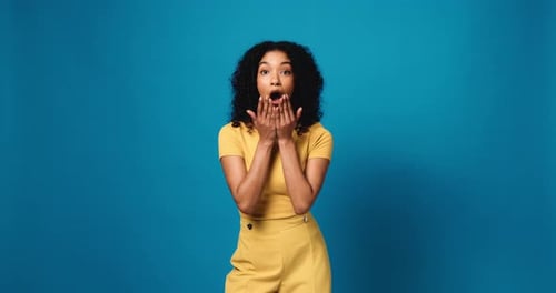 Gossip, wow and woman shocked face with secret, mistake or announcement in studio on blue