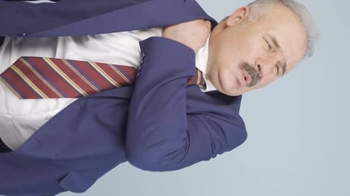 Man Rubbing Neck and Shoulder Due to Body Ache