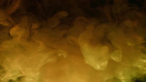 Abstract Swirls of Gold Paint Mixing in Water