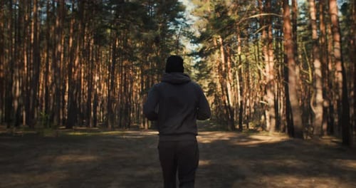 Young Man Running in Forest Marathon Training Spring Outdoor Training on Sunrise Fit Athete Sport