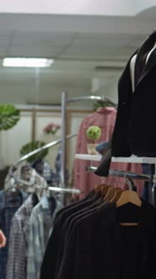 Woman Shopping for Clothes in Retail Clothing Store