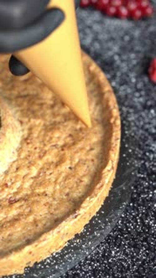 A skilled chef adding smooth caramel sauce to a delicious cake, close up shot, insert shot