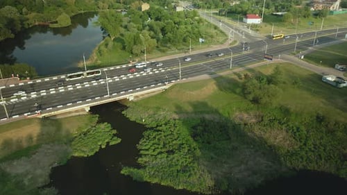 City Highway. Overpass Across The River. There Is Active Traffic On The Road. Aerial Photography.