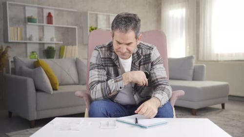 Worried Man Reviewing Finances at Home