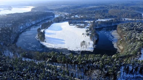 Aerial view of stunning river and forest in winter
