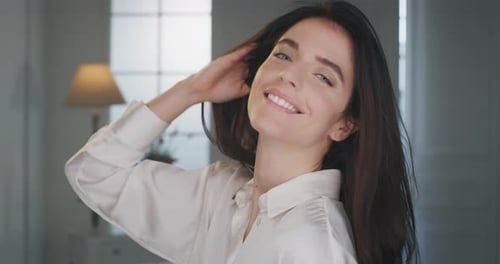 Woman With Long Hair Smiling In Doorway