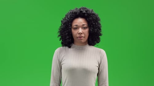 Young Adult Woman Playing With Hair on Green Screen