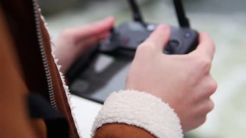 Person operating drone controller device close up shot
