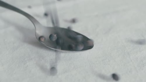 Juniper Berries Falling into a Spoon