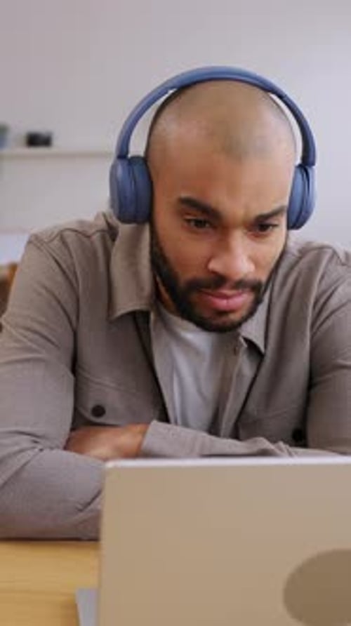 Young Adult African American Man Talking During Video Call at Home Office
