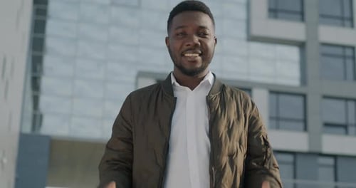 Excited Young Man Gesturing Approval in City Setting