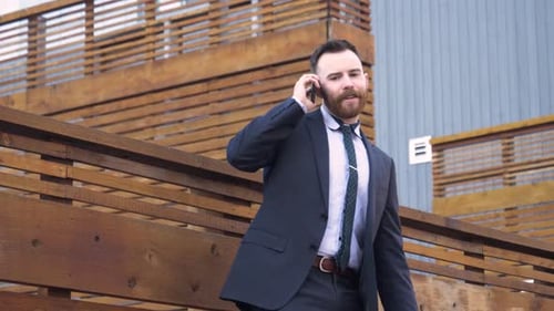 Man in Suit Talking on Phone Outdoors
