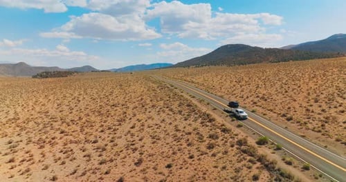 Car driving along the road in the valley. Highway riding desert road.