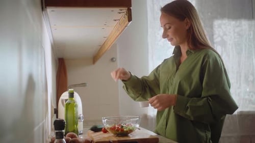 Cooking Healthy Salad in a Bright Kitchen with Fresh Ingredients and a Creative Approach to Meal