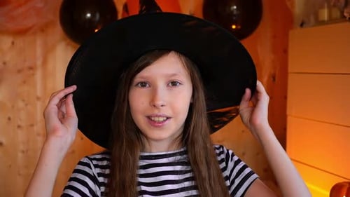 Smiling Girl Wearing Witch Hat Posing Indoors