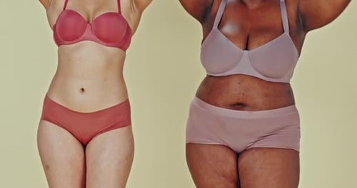 Holding hands, body and plus size women in underwear in studio isolated on green background