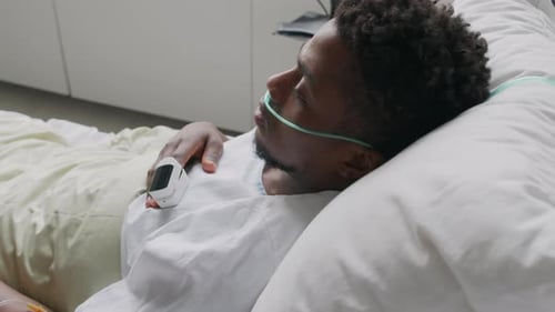 Sick Man Lying in Hospital Bed