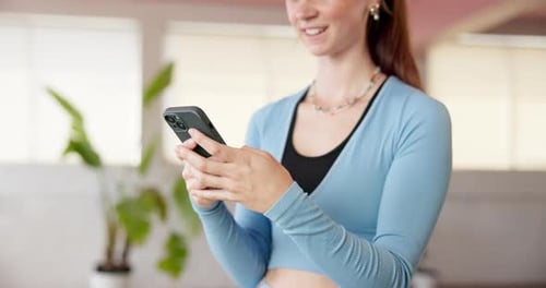 Typing, laugh or woman in fitness studio with phone, funny message or exercise video on social
