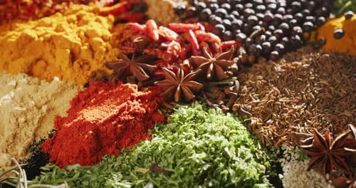 Close -up of a nice composition of spices and spoons on a turning base on bench. Concept: Food, tr