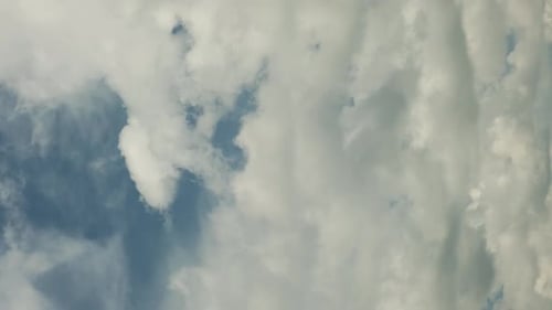 Dramatic time lapse of moving white clouds in stormy sky