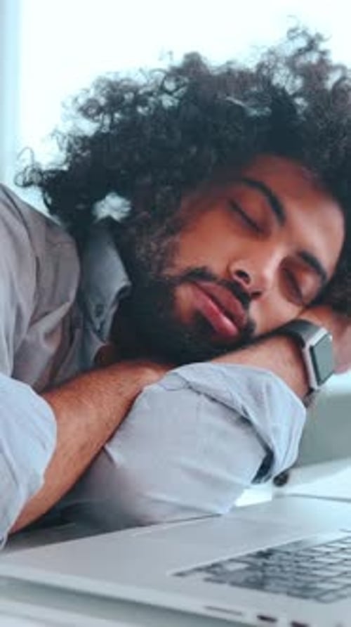 A Peaceful Moment of Rest for a Tired Young Man in a Cozy Setting