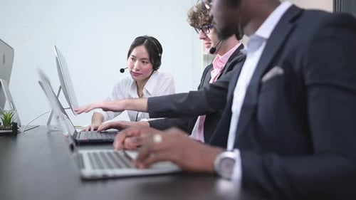 Group of business people wearing headset working actively in office.
