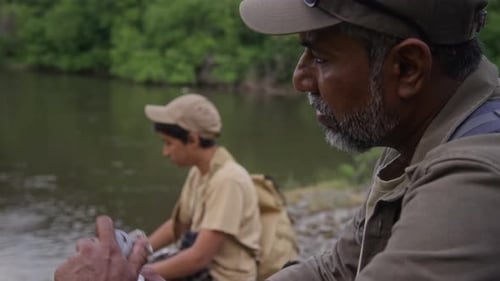 Adult and Child Fishing Near River