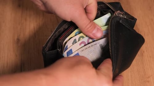 Close up, unzip wallet with euro money with tattooed male hands counting euro banknotes