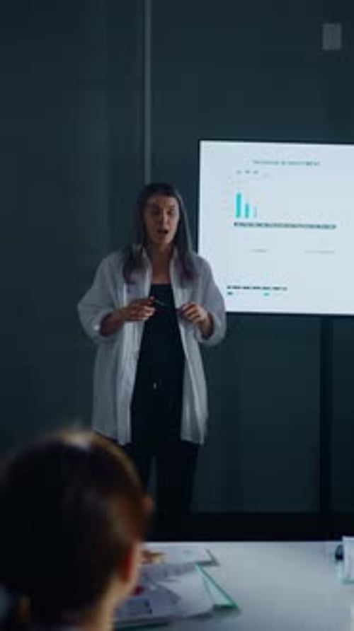Woman Presents Business Data in Boardroom Meeting