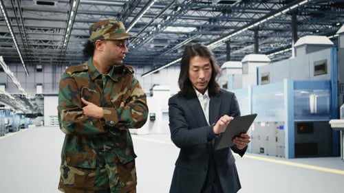 Soldier Speaks with Microchip Production Factory Senior Manager