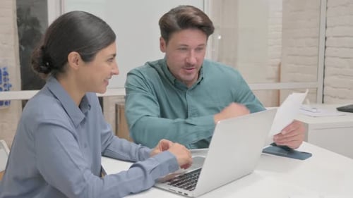 Multi Ethnic Teammates Doing Paperwork in Office