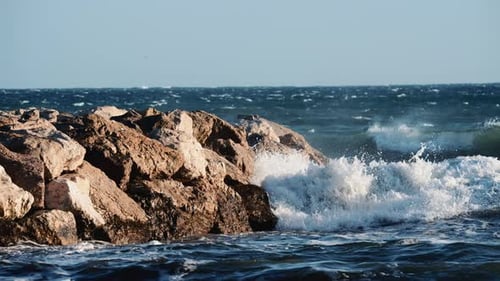 Ocean waves breaking and foaming as they approach the shoreline