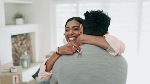 Keys, hug and a couple celebrate a new home, moving in together or renting real estate property